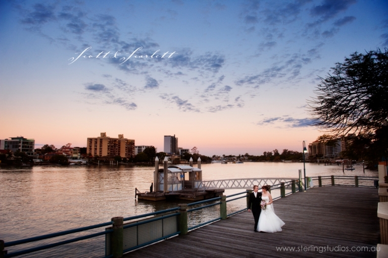 landing at dockside wedding bride and groom on the boardwalk at sunset